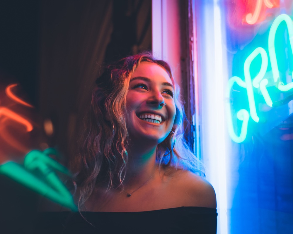 Portrait beside colorful neon lights